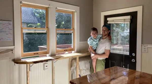 Homeowner and child in a remodeled kitchen.