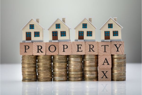 Property tax graphic with stacks of coins.