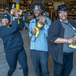 Homeowners holding tools.